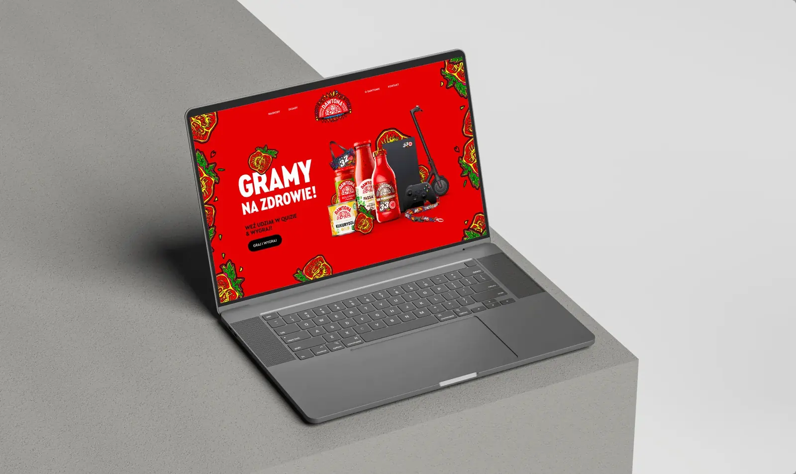 Strona quizu Moc Pomidora z hasłem „Gramy na zdrowie!” na laptopie.